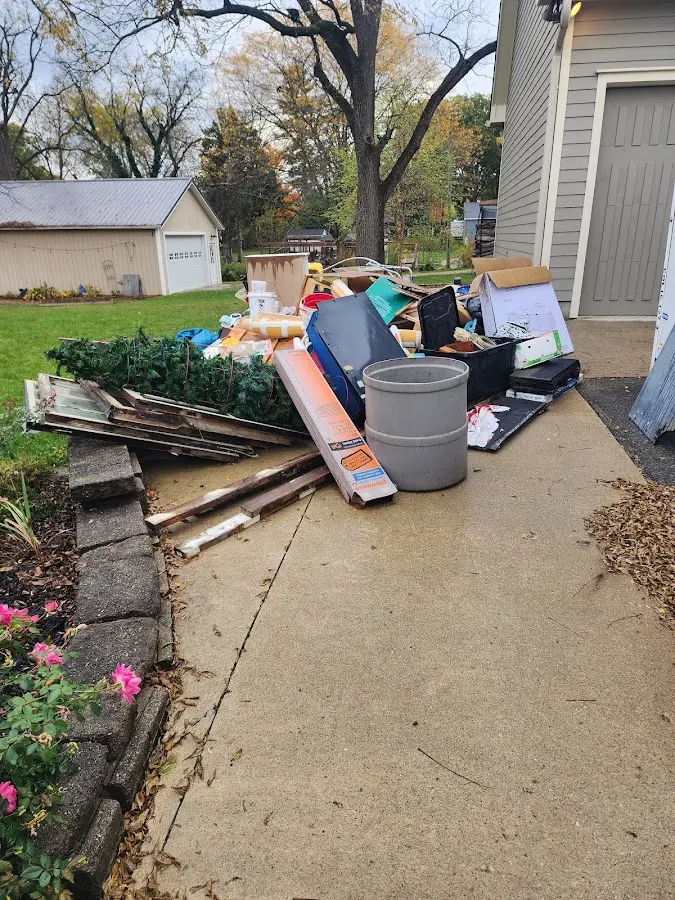 Dumpster being loaded with debris for Estate Cleanout Dumpster Rental in Golden Grove